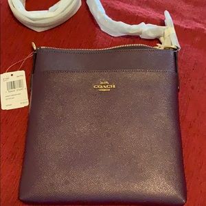 Coach cross body brass plum bag